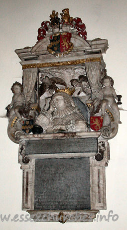 St Edmund, Abbess Roding Church - 


Monument to Lady Luckyln d.1633, consisting of a frontal demi-figure, with the 
head resting on one elbow, with a book in the foreground. Behind, two cherubs 
hold open a curtain. The monument has been attributed to Epiphanius Evesham, by 
J. Seymour.