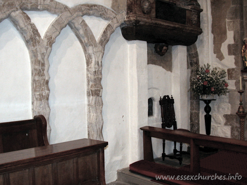 , East%Ham Church - The north nave wall. Note the glazed aperture to the left of 
the chair. This is the anchorite's cell.
