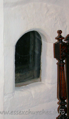 , East%Ham Church - This [now] glazed opening is the anchorite's cell. This is 
situated in the north nave wall.
