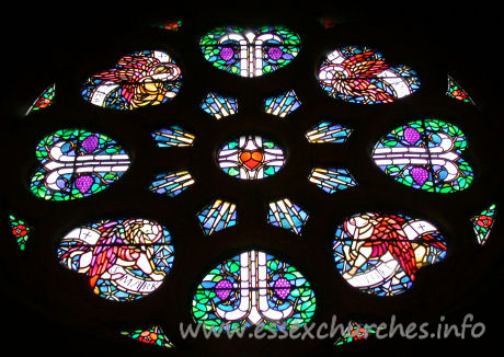 St Mary the Less, Great Warley Church – The rose window carries images of (from top left, clockwise) Ss Matthew, John, Luke and Mark. The window is the work of Heywood Sumner.