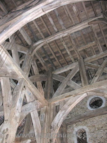 St Laurence, Blackmore Church – From Pevsner's Buildings of England: Essex... Internally it possesses ten posts, making a nave and two aisles. The tower itself stands on the centre six, three N and three S. The arched brances for the cross-beams run N-S, thrown across the second and the fourth pairs. In addition, there are smaller and lower arched braces in an E-W direction between posts 2 and 3, and 3 and 4. Above these are two tiers of cross-struts. A date of c.1480 has been suggested by Mr C.M. Hewett (Archaeological Journal, vol 119, 1962).Tree ring dating in 2004 has now suggested a date of around 1400 for these timbers.
