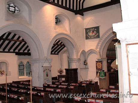 St Helen & St Giles, Rainham Church – The north arcade, showing the huge square piers. Note also, the two Early English wall arches, just to the left of the chancel arch. These constitute the only major later alteration.