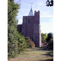 St Giles & All Saints, Orsett Church – Exterior 3: The W tower occupies the westernmost bay of the N aisle. It is partly stone, and partly C17 brick. It has a large diagonal buttresses, and as can be seen in this picture, a bulky NW stair-turret. At the top it sports a white weather-boarded spire.