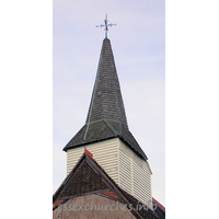 St Mary, Little Burstead Church – Exterior 4: The wooden belfry was constructed during the fifteenth century, and rests on six posts with beams on braces. It is crowned by a shingled broach spire.