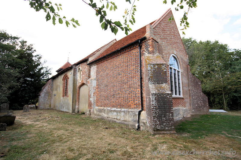 St Mary, Mundon Church – The south wall here shows the blocked S chapel archway, and the brick window, both dated early C16.