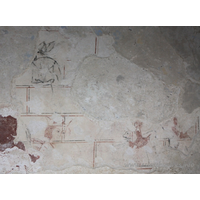 St Mary, Mundon Church – Miscellaneous 11: This is the earliest scheme of wall painting, and has recently been identified as the Martyrdom of St Edmund, King of East Anglia by Professor David Park, Courtauld Institute of Art, Conservation of Wall Paintings Department. He is crowned and the Danes are shooting arrows at him from in front and behind. === Only the head and shoulders of the Edmund figure, in three-quarter profile, remain, outlined in red, with his hair painted red and his eyes painted black. Behind the saint are vestiges of a bow, hand and arrow: the bow outlined in black; the arrow and hand in red. Facing him are the remains of two hooded figures in profile, the nearest is shooting another arrow: this and the figures are outlined in black; their hoods are red. === Above the Edmund figure is an unidentifiable figure outlined in black.