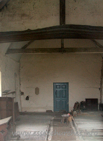All Saints, Berners Roding Church – The glimpse through the E window shows a peculiar door at the end of the church. Quite what this door is doing, I am unsure, as the other side of it is a blank wall.