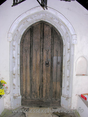St Michael, Ramsey Church – The S doorway is C15. One order of fleurons, the other of a king, queen and small shields.