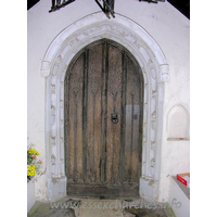 St Michael, Ramsey Church – Exterior 3: The S doorway is C15. One order of fleurons, the other of a king, queen and small shields.