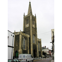 St Nicholas, Harwich Church – Exterior 2: Yellow brick, tall W tower with spire. castellated porches l. and r.