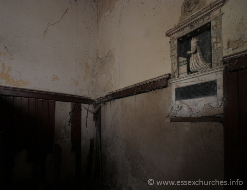 St John the Baptist, Mucking Church – At the east end of the S aisle. It was much darker in here than this photo suggests.