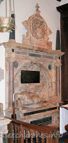 St Michael, Theydon Mount Church – Monument to Thomas Smith d.1577. This monument was moved from the old church. Sir Thomas is depicted 'stiffly' reclining, head propped up on elbow. There is a shallow coffered arch behind the figure, flanked by two Ionic columns, with an entablature carrying two black obelisks and the large achievement shown above. The inscription within the arched recess reads thus: Thomas Smithus Eques auratus huius Maneriu DNS, cum Regis Edvardi sexti tum Elizabatha Regina Consiliarius, ac frimi nominis Secretarius eorundemq, Principum ad maximos Reges legatus Nobiliss ordinis Garterii Cancellarius, Ardae Australisque Claneboy in Hibernia Colonellus, Iuris civilis supremo titulo etiam num Adolescens insignitus Orator, Mathematicus, Philosophus, excellentiss (vs) Linguarum Latinae, Grecae, Hebraicae, Gallicae etiam et italica callentiss (vs) Proborum et ingeniosorum hominum favtor alieniss Deniq sapientia, pietate, integritate insignis et in omni vita sev aeger sev valens intrepidus more, cum aetatis svae 05m annum compleuisset in aedibus suis Montaulensibus 12o die Augusti, Ao Salutis 1577 pie et suauiter in Domino obdormiuit
