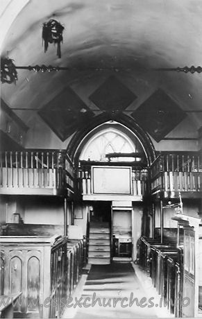 St Michael, Theydon Mount Church – This black and white photograph is on display in the church. The West Gallery was built in 1837, during a restoration by Sir Edward Smyth, the then rector. The gallery was installed for use by servants and musicians. It was, however, removed in 1929, as it was in grave danger of collapsing. Suspended from the roof are two 'Coronals' or 'Maiden's Crowns'. These represent an old custom of placing such a crown on the coffin of a girl who had been betrothed, but had died before her marriage. They are shaped like a crown and are covered with evergreen leaves. There were originally three of these crowns in the church. Today there is just one remaining, though this is currently undergoing preservation and restoration. More details on this restoration can be found by clicking here.