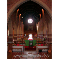 All Saints, Southend-on-Sea Church – Interior 3: Looking west from the chancel, the high semicircular wagon type roof is just visible. The chamfered piers are decorated by alternating bands of brick and stone.