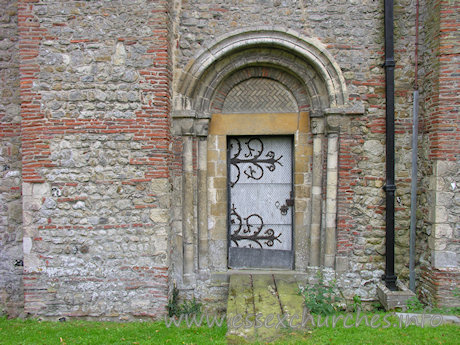 St Michael & All Angels, Copford Church – The N doorway into the nave is Norman. It has two orders of columns with primitive capitals, and two roll mouldings in the arch.