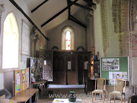 St Michael & All Angels, Copford Church – Looking W in the S aisle. The difference in the brick styles can be seen clearly here, with the Roman bricks to the left, and the home-made or imported bricks to the right.