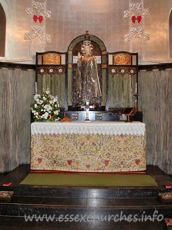 St Mary the Less, Great Warley Church - The chancel lower-wall is covered with a grey-green marble, 
and the ribbed vault is a metallic colour.
The centrepiece of the reredos is a striking figure of Christ. 
No question of what our attention should be grabbed by here then!

