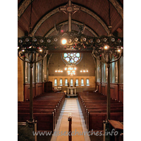 St Mary the Less, Great Warley Church - The view west gives us our first proper glimpse of the 
magnificent W rose window, by Heywood Sumner.
The
church's website 
gives some more information on this artist.
Also present, but rather shaded in this view, is the 
magnificent chancel screen, shown more clearly (though not fully) in the 
Miscellaneous area.

