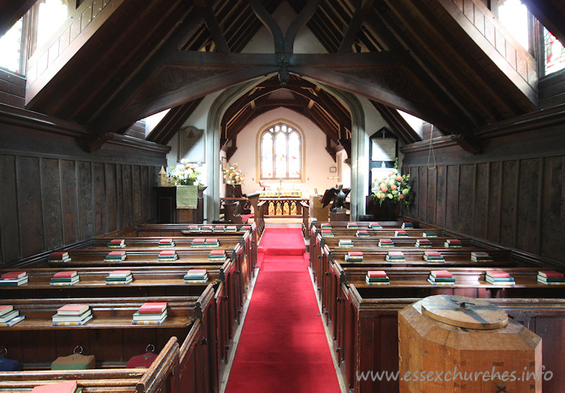 St Andrew, Greensted Church - An internal view of the chancel. Prior to the C16, the chancel was built of wood. It pre-dated the nave, and would originally have been the only part of the building. It would have been of a more primitive construction than the nave.
 
Around 1500 A.D., during the reign of Henry VII, great changes were made to the church. The chancel was rebuilt in brick, and the thatched roof on both the nave and chancel was replaced by tiles. Dormer windows were added to the nave.
