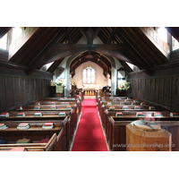 St Andrew, Greensted Church - An internal view of the chancel. Prior to the C16, the chancel was built of wood. It pre-dated the nave, and would originally have been the only part of the building. It would have been of a more primitive construction than the nave.
 
Around 1500 A.D., during the reign of Henry VII, great changes were made to the church. The chancel was rebuilt in brick, and the thatched roof on both the nave and chancel was replaced by tiles. Dormer windows were added to the nave.
