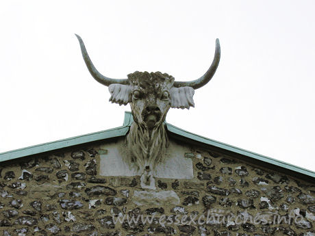 St Andrew, Hornchurch Church - Taken from the church's own website
The horned bull's head on the east end of the chancel is an unusual feature to find on a church, as horns are more generally associated with the devil. It would seem that the church had the horned bull before the town was called Hornchurch, as the first written reference, in 1222, refers to 'monasterium cornutum' or 'horned church/monastery' at Havering. The first reference to the horns on the east end of the church is in 1610 when they were said to be made of lead. When they were repaired in 1824 they were found to be of copper. It is reasonable to suppose they had been replaced during the intervening 200 years, but neither mentions the stone head, merely the horns. There are numerous legends and theories to explain their existence and whilst the truth may remain obscure the head forms a unique feature of the church.
In 1999 the copper horns were stolen from the bulls head. The horns are priceless and were never recovered. The Horns were replaced in 2001 allowing Hornchurch to live up to its name.