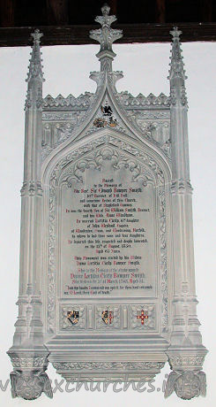 , Theydon%Mount Church - 





Large Perpendicular Gothic tablet to Rev Sir Edward Bowyer Smith d.1850, by Osmond, Sarum.	
	Sacred
to the Memory of
The Revd Sir Edward Bowyer Smijth.
10th Baronet of Hill Hall;
and sometime Rector of this Church,
with that of Stapleford Tawney.
He was the fourth Son of Sir William Smijth, Baronet,
and his Wife, Anne Windham.
He married Laetitia Cicely, 6th daughter
of John Weyland, Esquire,
of Woodraton, Oxon, and Woodrising, Norfolk,
by whom he had three sons and four daughters.
He departed this life, respected and deeply lamented,
on the 15th of August, 1850.
Aged 65 Years.
This Monument was erected by his Widow
Dame Laetitia Cicily Bowyer Smijth.
Also to the Memory of the above-named
Dame Laetitia Cicely Bowyer Smijth.
She died on the 3rd of March 1863, Aged 31 [???]
"Into thy hands I commend my spirit,
for thou hast redeemed
me. Oh Lord, thou God of truth."
