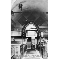 St Michael, Theydon Mount Church - 


This black and white photograph is on display in the church.

The West Gallery was built in 1837, during a restoration by 
Sir Edward Smyth, the then rector. The gallery was installed for use by servants 
and musicians. It was, however, removed in 1929, as it was in grave danger of 
collapsing. 
Suspended from the roof are two 'Coronals' or 'Maiden's 
Crowns'. These represent an old custom of placing such a crown on the coffin of 
a girl who had been betrothed, but had died before her marriage. They are shaped 
like a crown and are covered with evergreen leaves. There were originally three 
of these crowns in the church. Today there is just one remaining, though this is 
currently undergoing preservation and restoration. More details on this 
restoration can be found by clicking
here.
















