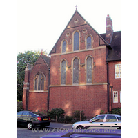 All Saints, Southend-on-Sea  Church - To be fair, the East end of the church would probably not look 
as plain as it does, if it was not immediately adjacent to the living and 
functional quarters of the church.
The bright areas upon the wall are caused by the reflections 
of the sun against the windows of the block of flats directly opposite the 
church.


