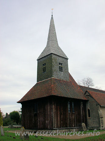 St Margaret of Antioch, Margaretting Church - My visit was on rather a gloomy looking day, but, despite the 
darkness, the sheer size of the tower is easily discerned.
Like nearby Blackmore, the tower sits on ten posts. Three 
pairs of arched braces connect free standing posts in the N-S direction, whilst 
from E-W, the posts are spanned by lower and smaller arched braces.




