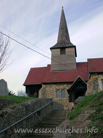 St Nicholas, Laindon Church - This view up to the church shows the timber belfry, with its 
dark weather-boarding, and its broach spire.




