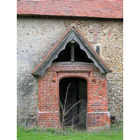 Dedication Unknown, Mashbury Church - This tudor brick porch was built approx 1500. The roof of both 
this porch, and the nave are C15.
Note the obsured Norman window, and the cross shape, formed 
from tiles.
