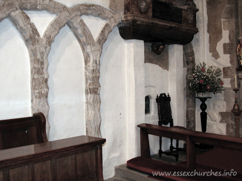 St Mary Magdalene, East Ham Church - The north nave wall. Note the glazed aperture to the left of 
the chair. This is the anchorite's cell.
