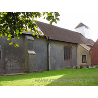 St James, Little Clacton Church - The N side of the church, showing a brick window (likely C16) in the nave wall.