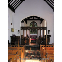 All Saints, Nazeing Church - The chancel arch, with screen. The two strange objects to either side of the arch are the remains of the rood screen supporting structure. Higher, and to the left, can be seen the remains of the rood beam.